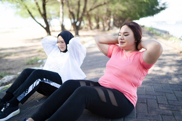 cropped view of asian women sit up together before exercise