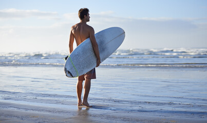 Fitness, surfing and back of man at a beach with surfboard for freedom, travel or sports outdoor....