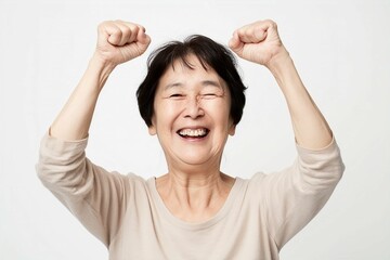 歓声をあげて応援する笑顔の日本人女性のおばあちゃん（白背景・オリンピック・日本代表・ワールドカップ・世界大会・Jリーグ・野球・スポーツ）