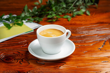 Classic coffee in a cup, Americano on a wooden table.