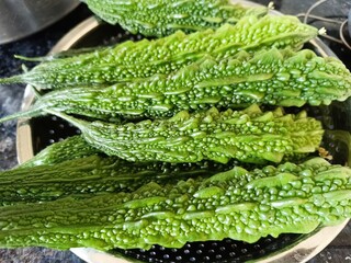 Closeup view of fresh bitter gourds in a bowl