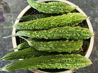 Closeup view of fresh bitter gourds in a bowl