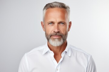 Portrait of handsome mature man with grey hair and beard looking at camera