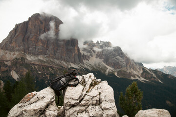 Traveller bagpack in breathtaking landscape of Dolomites Mounatains. Travel lifestyle wanderlust adventure concept.
