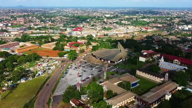 Aerial view of traffic on the streets in front of the Basilica of Mary Queen of Apostles, in sunny Yaounde, Cameroon