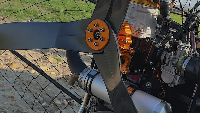 Closeup detail of engine and propeller of paramotor paraglider frame