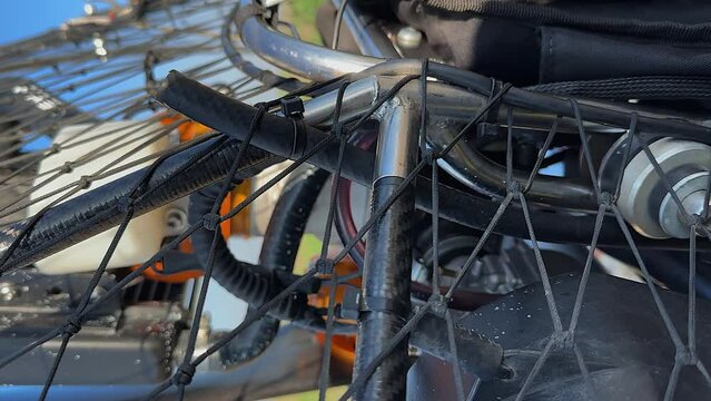 Vertical format: Close-up detail of paramotor paraglider steel frame