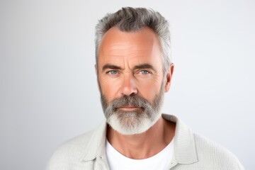 Portrait of handsome mature man with grey hair and beard. Studio shot.