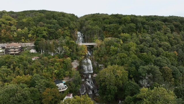 Hector Falls - Gigantic Waterfall Flowing Through The Forest In Autumn In New York, USA. - aerial shot