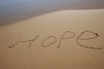 Hope word drawn on the beach