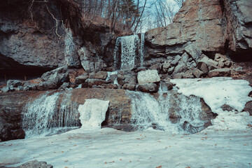 Small waterfall in a rocky area in spring. Environment. Wild nature.