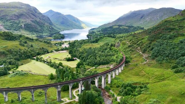 Drone Scotland 4k. Aerial view Glenfinnan viaduct bridge, on which famous Jacobite train runs in Scotland. Jacobite Railway scenic tourism attraction in Britain. 