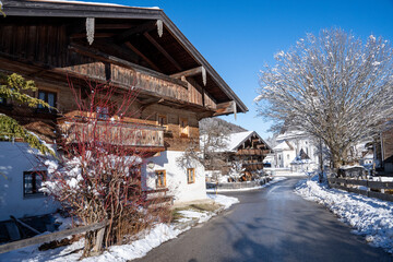Village street of the mountaineering village of Sachrang in Chiemgau, Bavaria, Germany in winter....
