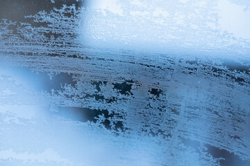 Abstract frosty patterns on a frozen window, background