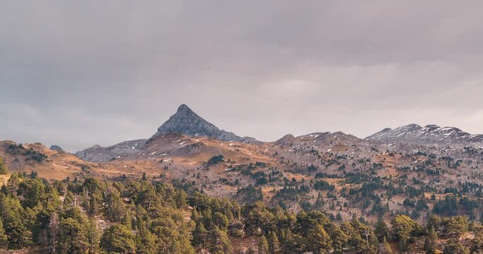 Close up Timelapse of Pic d Anie mountain in Spain France border under cloudy dramatic sky in a fall autumn day