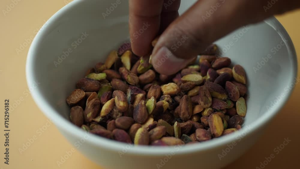 Wall mural hand pick natural Pistachio kernel nuts  - Wall murals