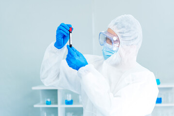 Scientist man holding sample blood test tube in science laboratory. Doctor clinic healthcare...
