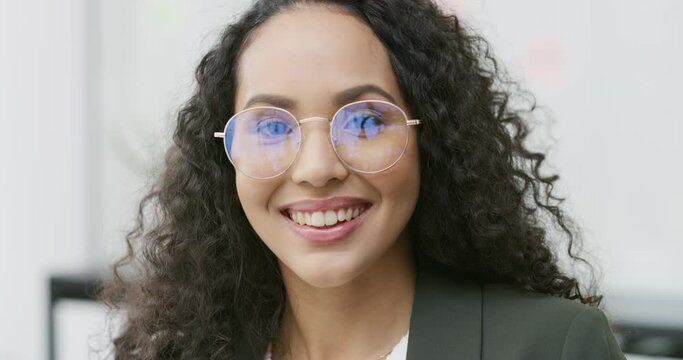Smile, glasses and face of business woman in the office with positive, good and confident attitude. Happy, vision and portrait of young professional female designer from Colombia with creative career