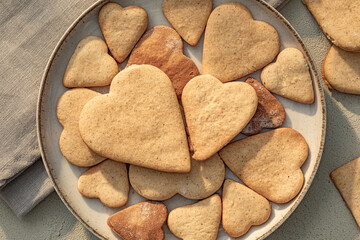 Heart-shaped cookie in plate on table