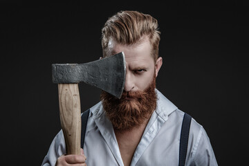 Brutal man in suspenders with ax isolated on black. Mature redhead man with hairstyle. Brutal male...