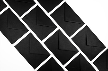 Top view of black envelopes on white background. Post flat lay. Copy space.