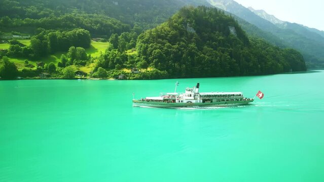 Drone Switzerland 4k. Old steamboat ship tourist boat on lake Thun Brienz in Interlaken. Beautiful Swiss Alps mountains, alpine lake. Switzerland tourism in summer. 