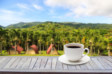 Hot coffee mug on mountain view background, camping, vacation concept, relax