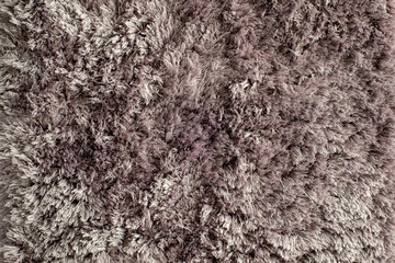 Closeup view of a mauve light purple fluffy artificial fur surface for a backdrop