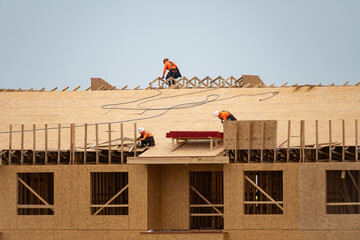 House roof. Roofing construction. Roofer using air nail. Roofing tiles of the new roof under...