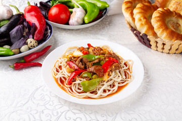 Homemade noodles with beef and pepper. Eastern cuisine. Uzbek cuisine.