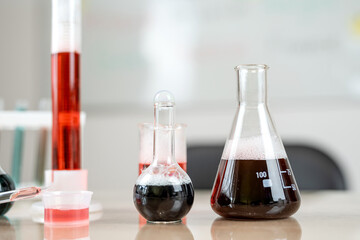 chemical concept at group of flasks with different colored liquid