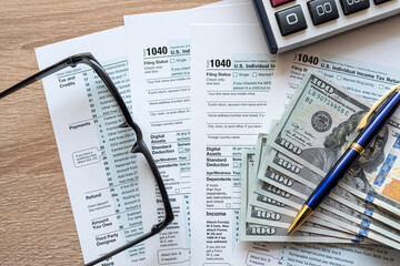 2023 tax form 1040 us  money and glasses, taxation concept