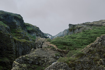 Moody green and rocky hiking trail to Glymur waterfall