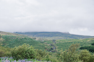 Moody background of Iceland countryside with cloudy sky and river