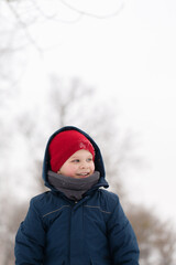 Fototapeta na wymiar Portrait of a cheerful boy on a walk