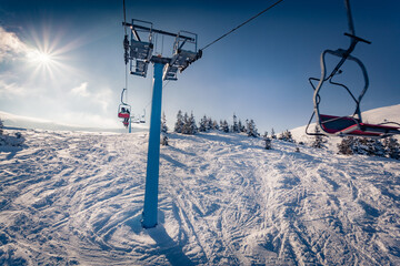 Attractive winter view from the chairlift of snowy hills on Dragobrat ski resort. Breathtaking...