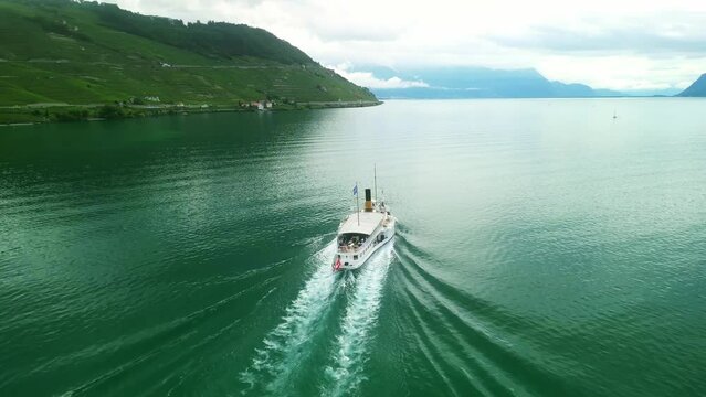Drone Switzerland 4k. La Suisse steamboat ship on Lake Geneva. Swiss Flag. Geneva to Lausanne tour, Lac Leman, Switzerland summer tourism destination. Turquoise blue water.