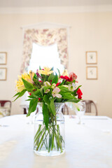 Colorful Flowers in Vase on White Dining Table