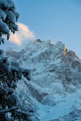A bottom up view to the ice cold and with snow covered Zugspitze mountain chain and the surrounding...