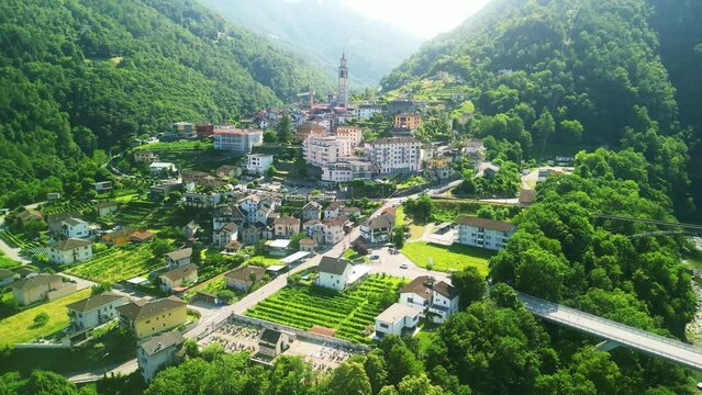 Aerial drone view of scenic swiss train Vigezzina-Centovalli Railway in Intragna village. between Domodossola and Locarno. Ticino Switzerland. Swiss Alps in summer, 4k.