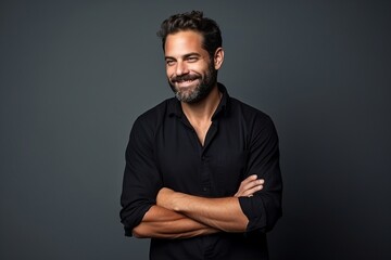Handsome middle age man with beard and mustache in black shirt over grey background. - Powered by Adobe