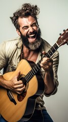 Bearded male musician playing guitar happily white background