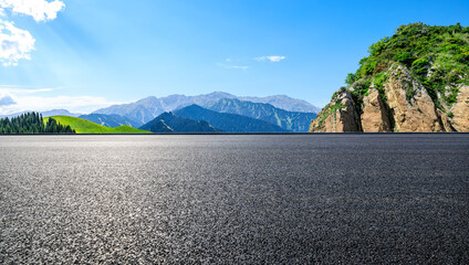 Asphalt road and mountain natural landscape under the blue sky