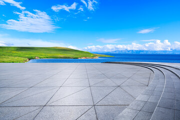 Empty square floor and green grass with beautiful coastline natural landscape under the blue sky