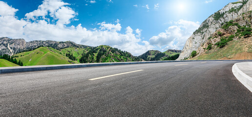Asphalt highway road and mountain nature landscape under blue sky. Panoramic view.