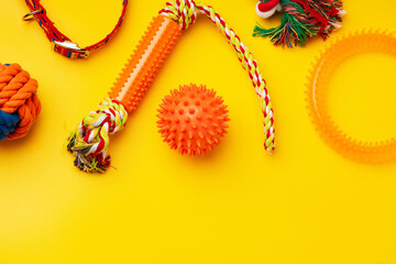 Pet toys on yellow background studio shot