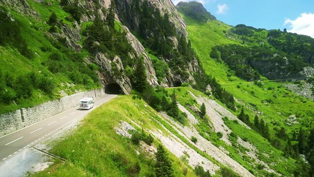 Aerial drone view of scenic Susten pass drive in Swiss Alps. Switzerland summer tourism destination. Alpine road trip road. 
