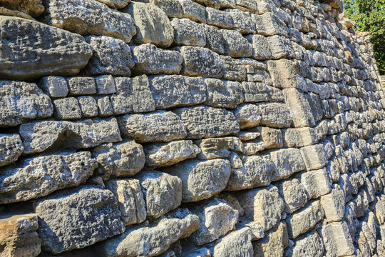 Archaeological site of ancient Troy. Reconstructed wall around excavated ancient city. Hisarlik hill. Tevfikiye (Cankkale), Turkey (Turkiye)