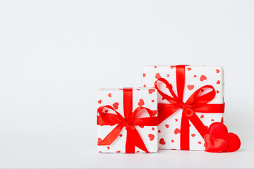 gift box with red bow and red heart on colored background. Perspective view. Flat lay