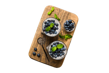 Healthy breakfast or morning with chia seeds vanilla pudding and blueberry berries on table background, vegetarian food, diet and health concept. Chia pudding with coconut milk and blueberry